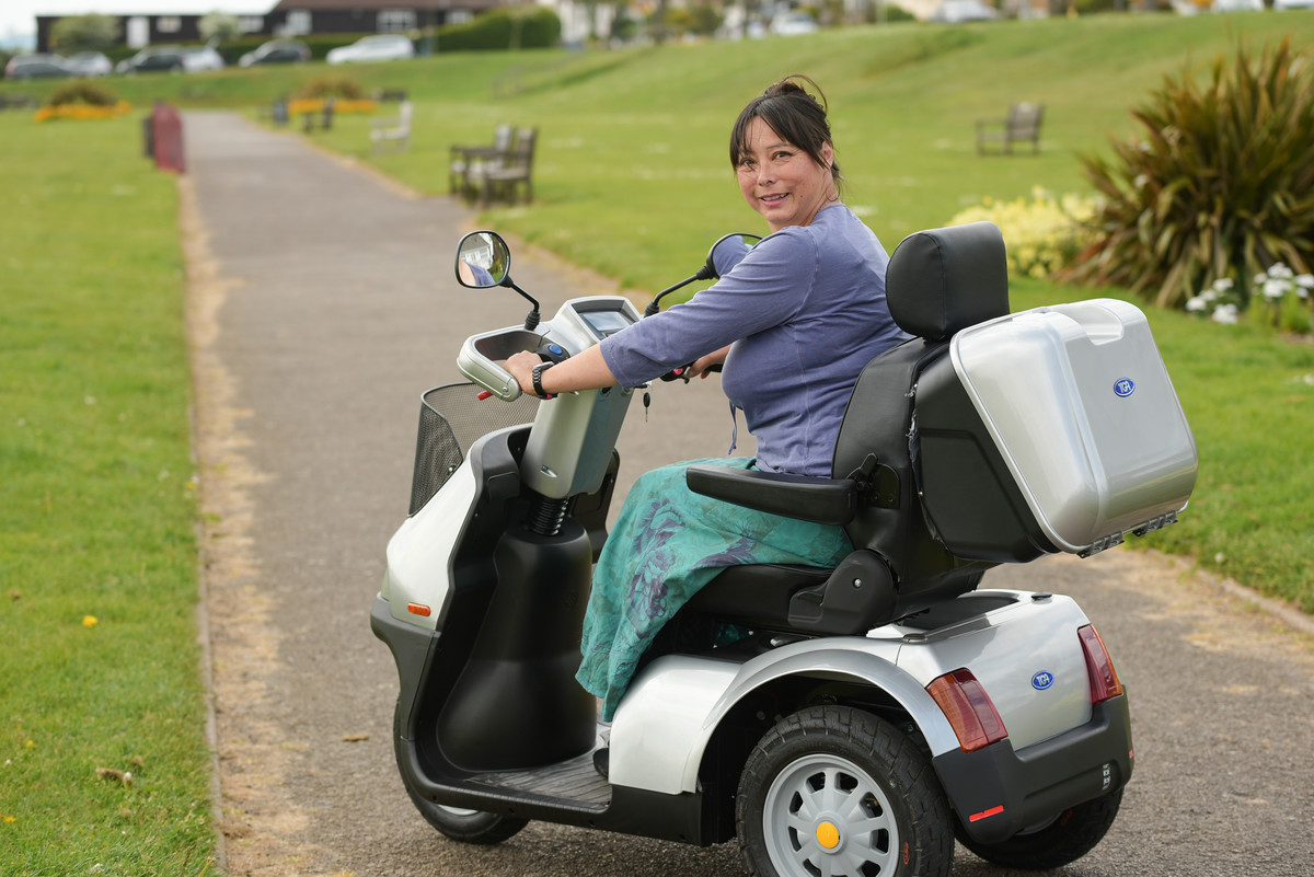 Lady using mobility scooter outside.jpg