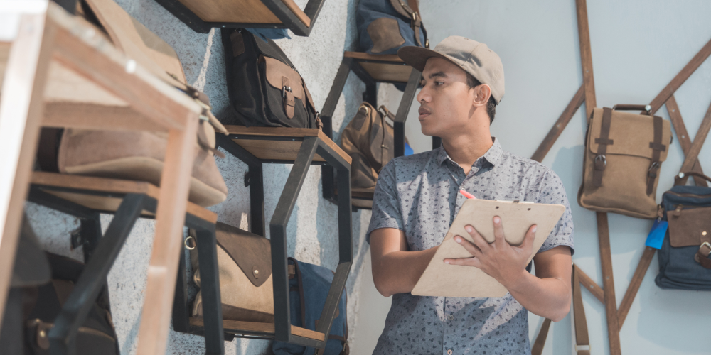 business owner check the quality of his product at bag store