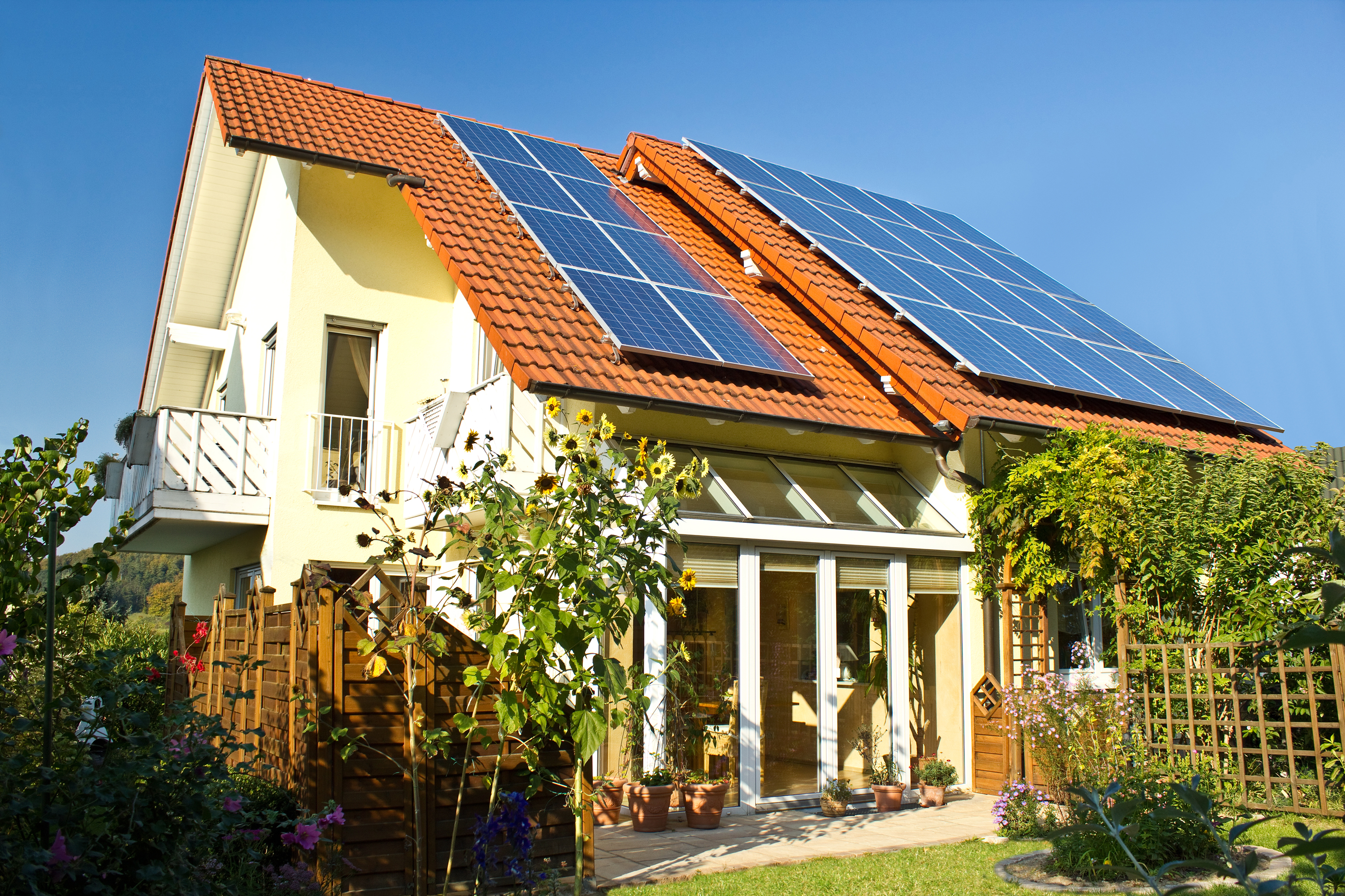 Solar panels on roof of house in late summer