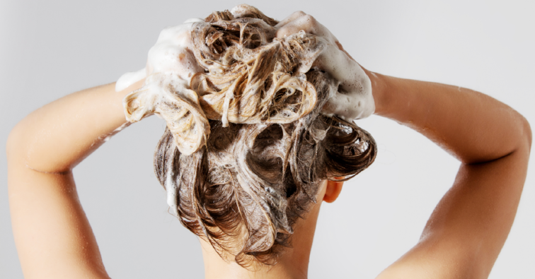 Woman washing her blond hair