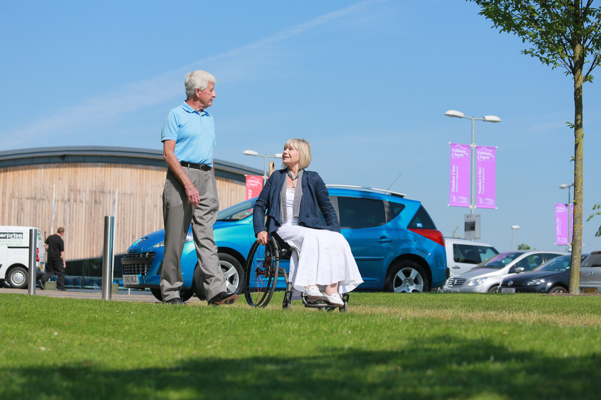 Wheelchair user with car