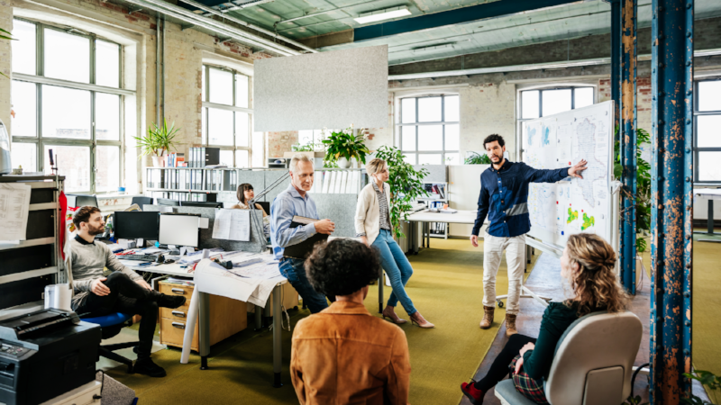 Office Manager Addressing His Team During Morning Meeting