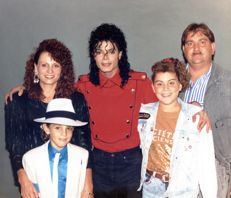 Wade Robson wears a suit from the "smooth criminal" music video and poses with his family and Michael Jackson