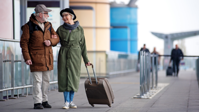 Pleasant senior couple is situating near airport