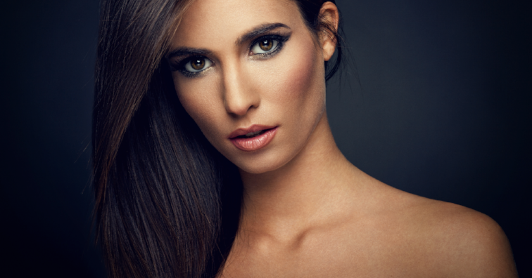 Young woman with straight hair on dark background