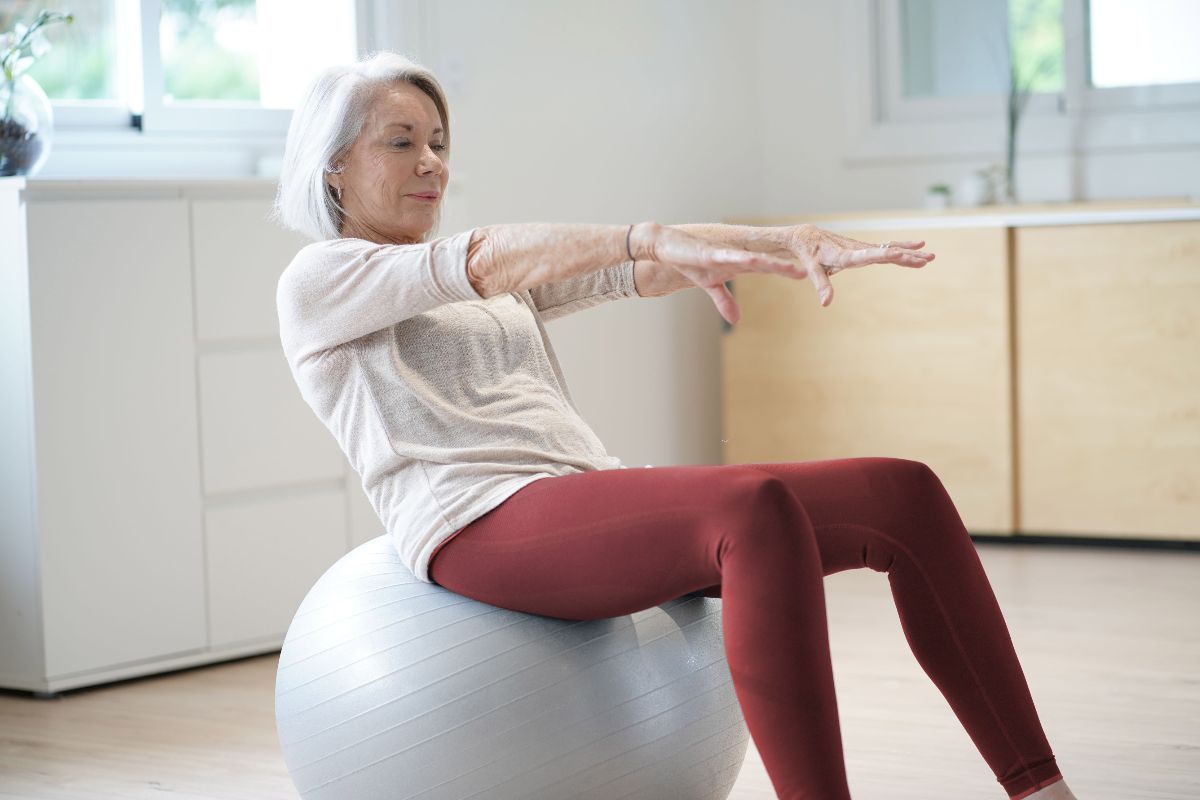 woman exercising at home with swiss ball
