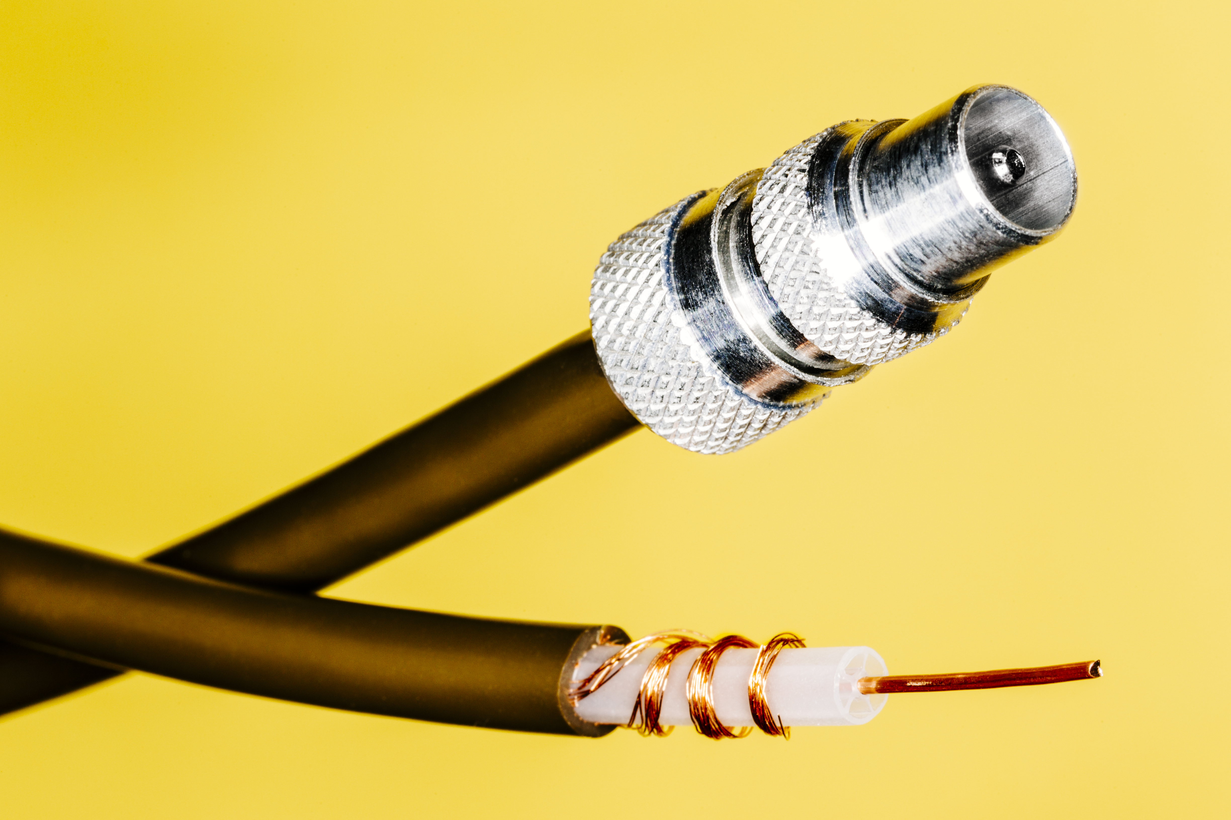 Coax plug in yellow background