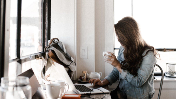 Woman working in laptop with coffee mug