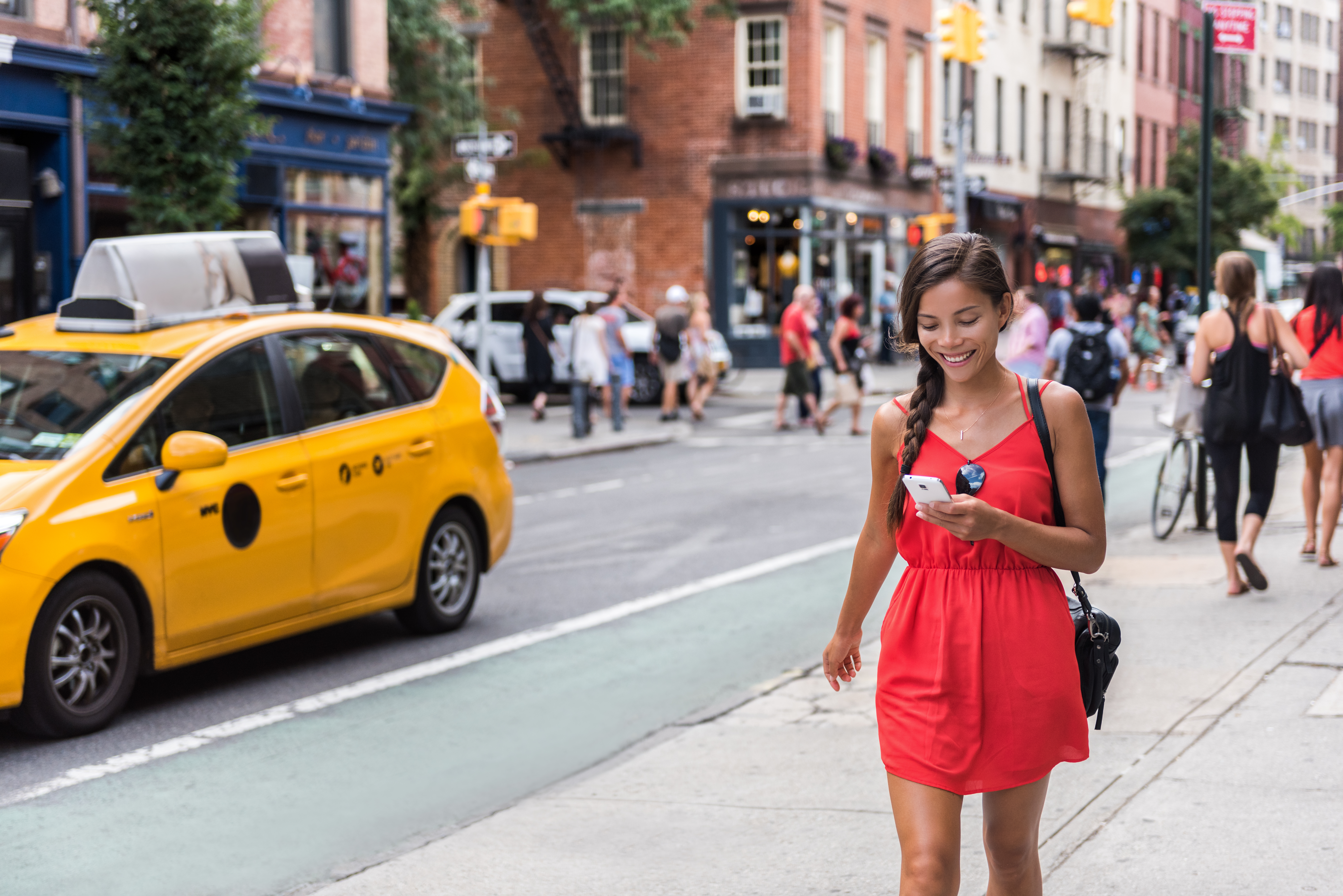Woman walking in new york city using phone app