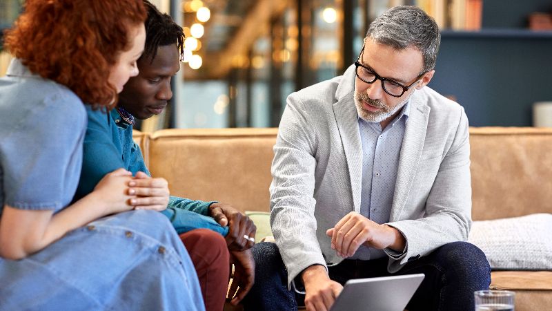 Financial adviser planning with clients at office