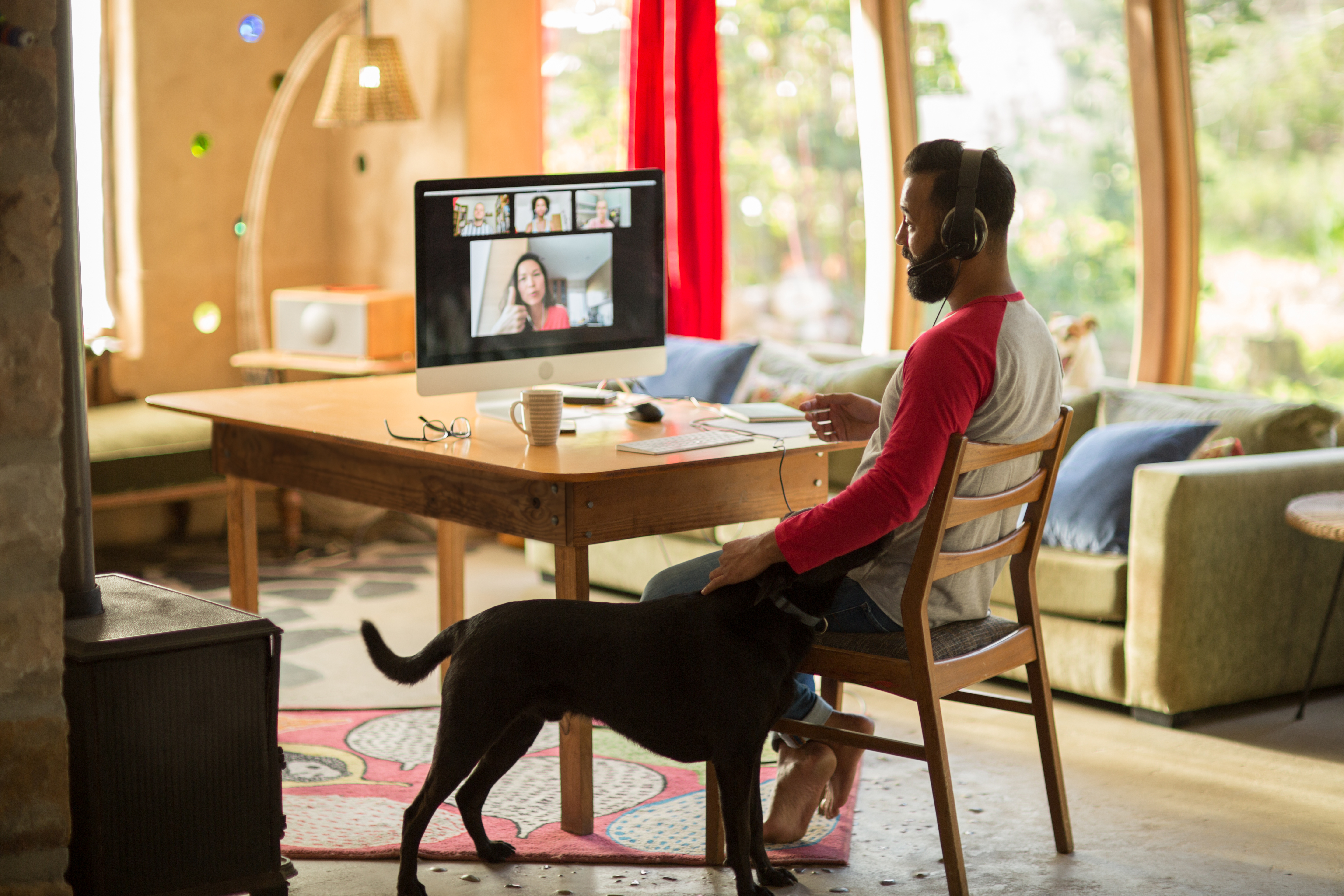 Mixed race man working from home on his computer during lockdown