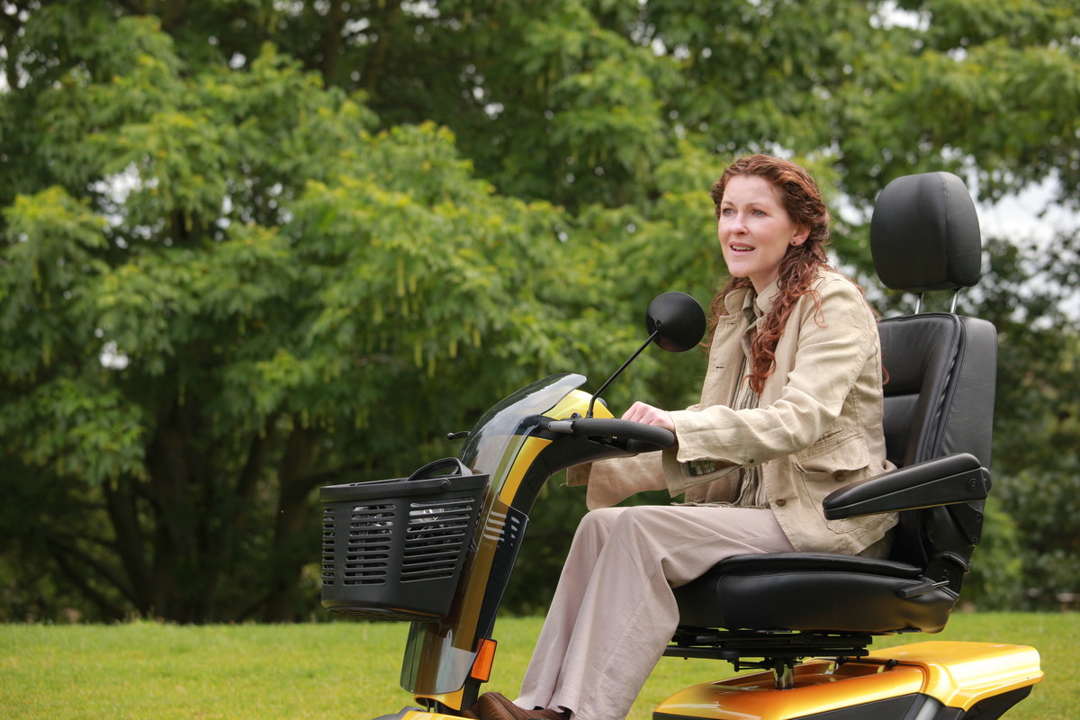 Lady driving mobility scooter.jpg