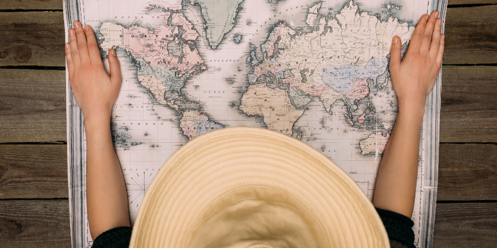 woman in hat with map