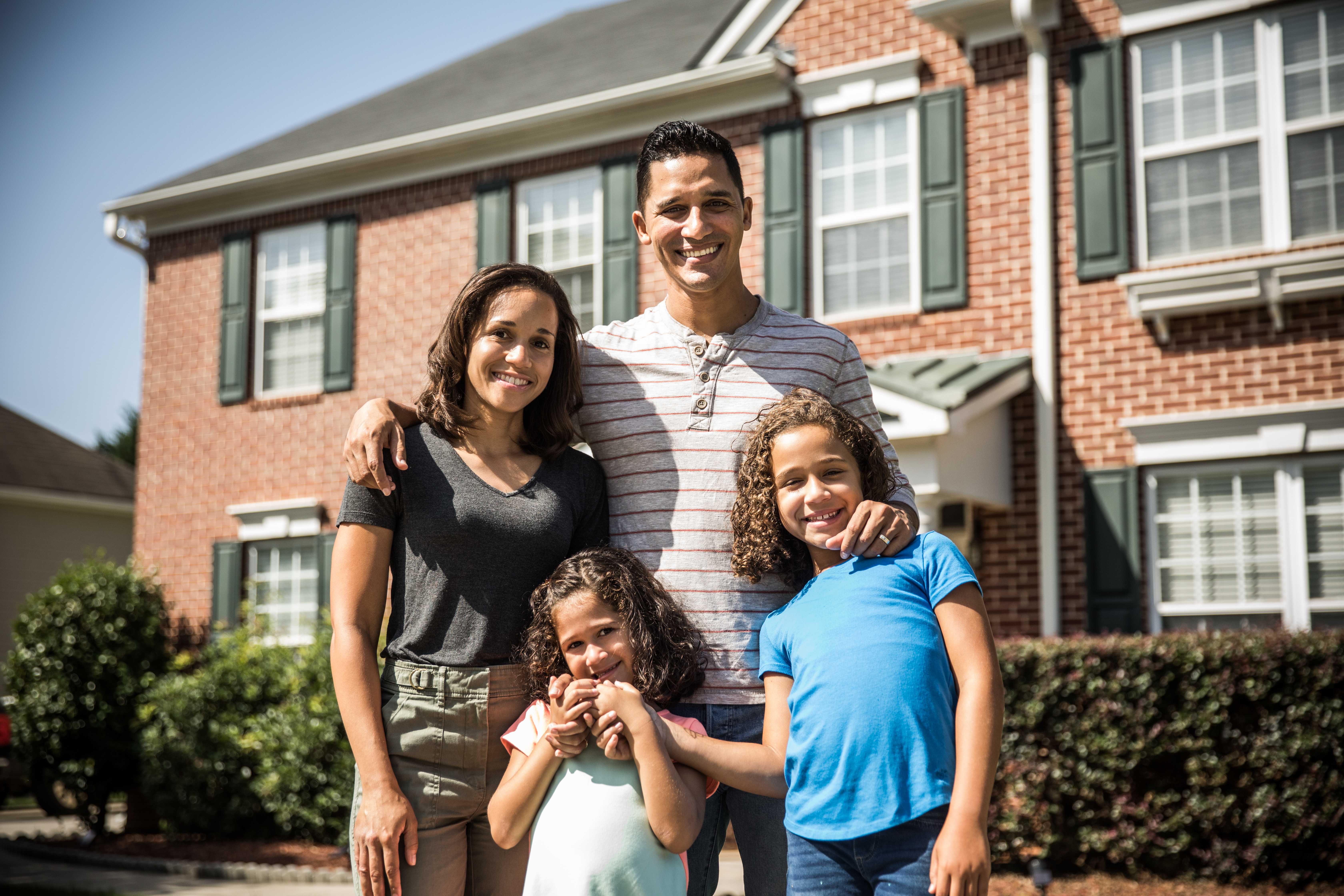 Portrait of family outside of their home