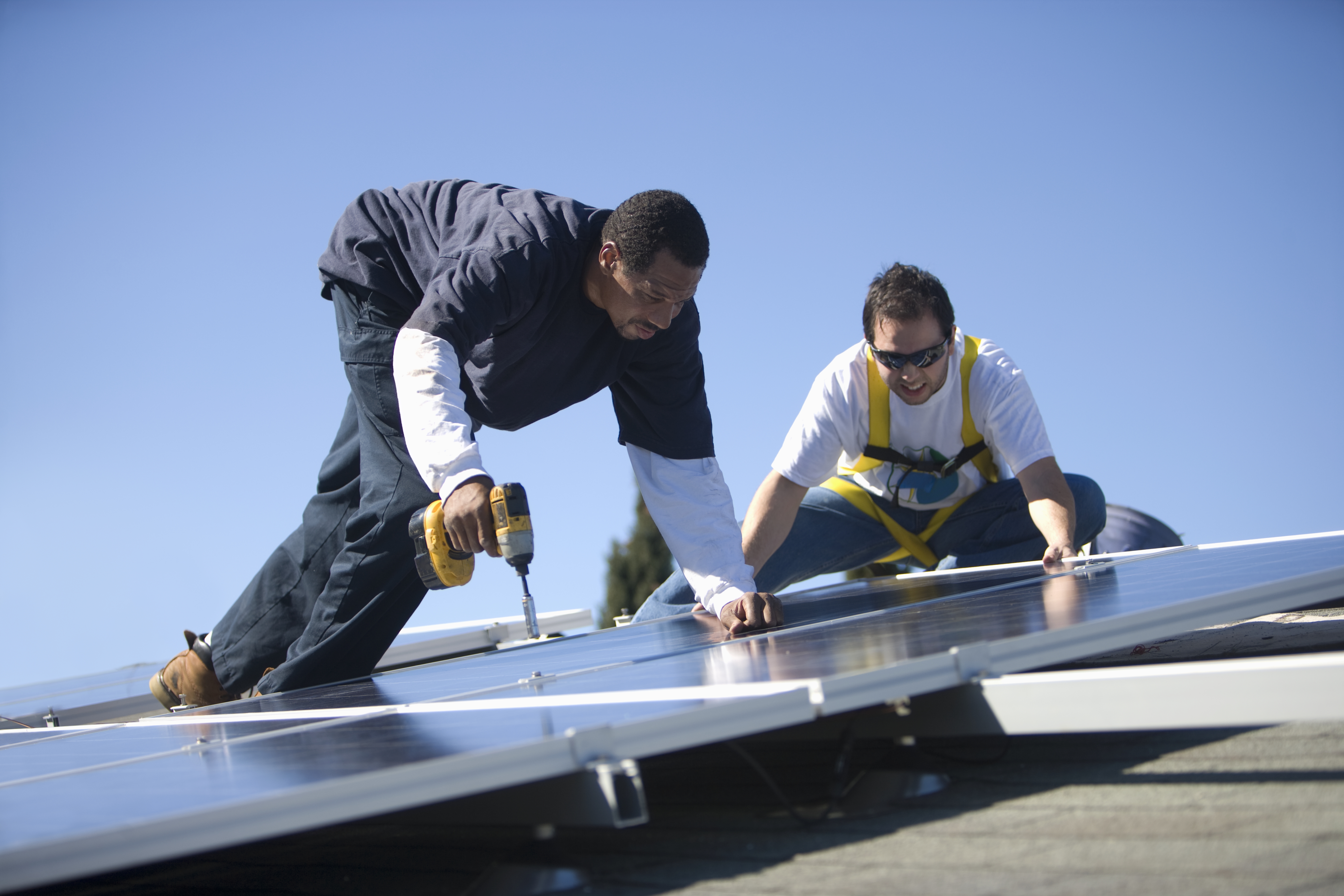 Two men working on solar panelling