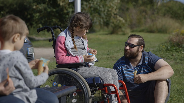 Father assisting disabled daughter