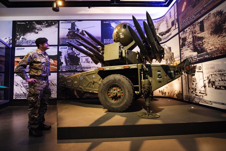 A British Army soldier surveys an exhibit at the National Army Museum