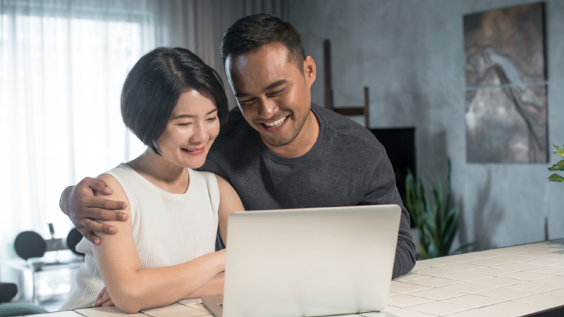 Asian Couple Using Laptop