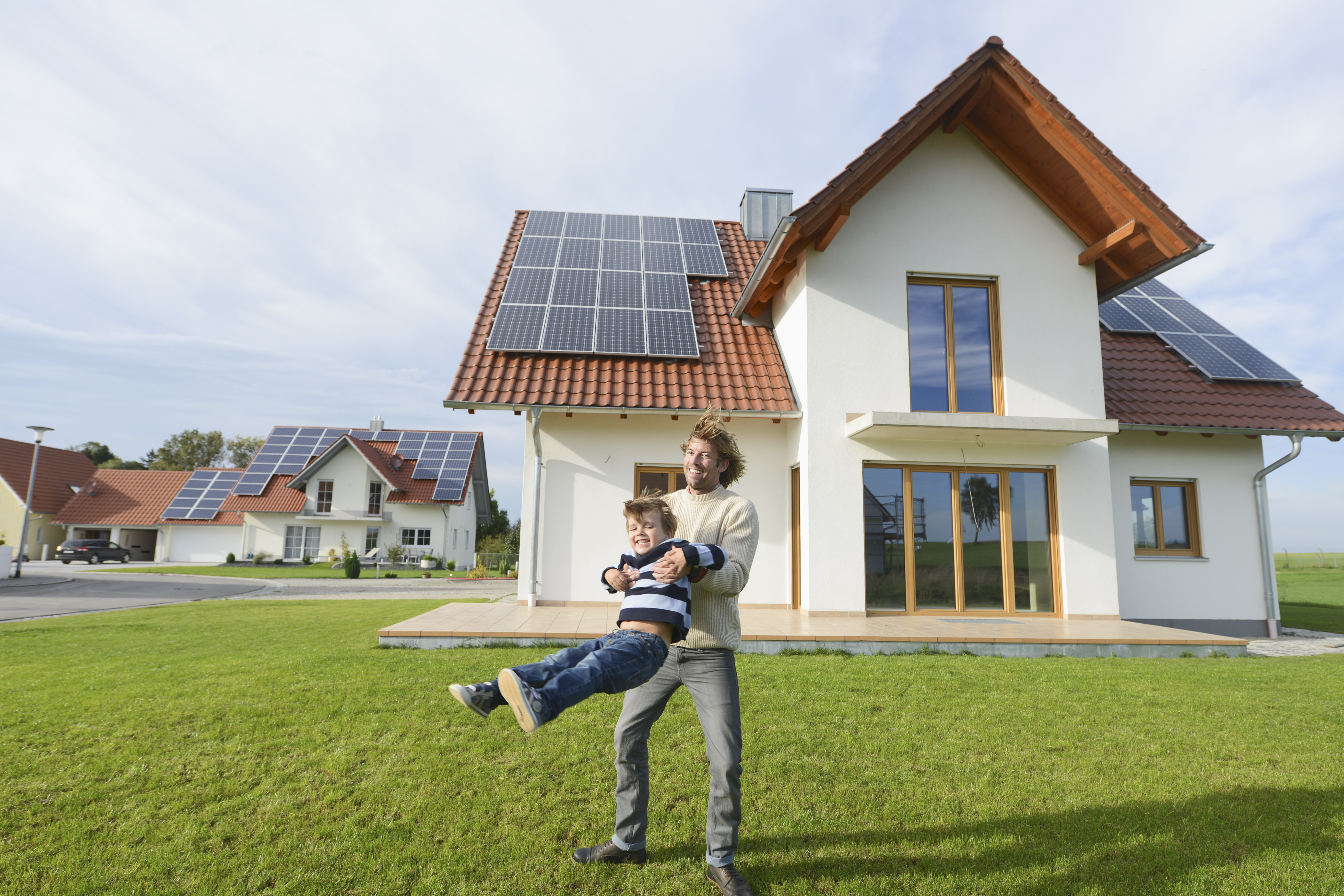 Mid adult man playing with son on lawn