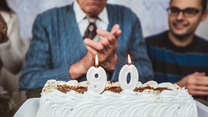 Elderly man celebrates birthday with family