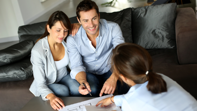 Couple meeting adviser for property purchase