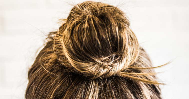 Head of a young woman from behind. Hair bun