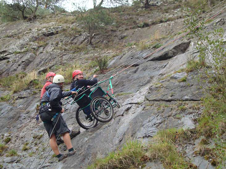 Members from BLESMA, the charity for limbless veterans, scale a quarry wall