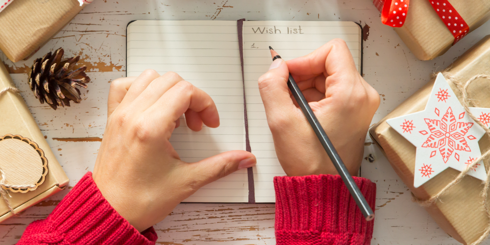 Making list of presents on wood background