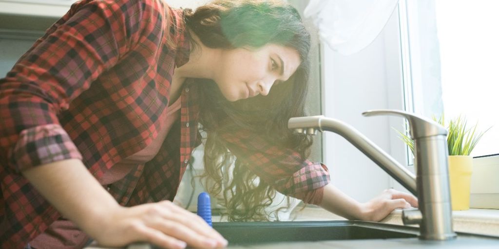 Woman checking sink